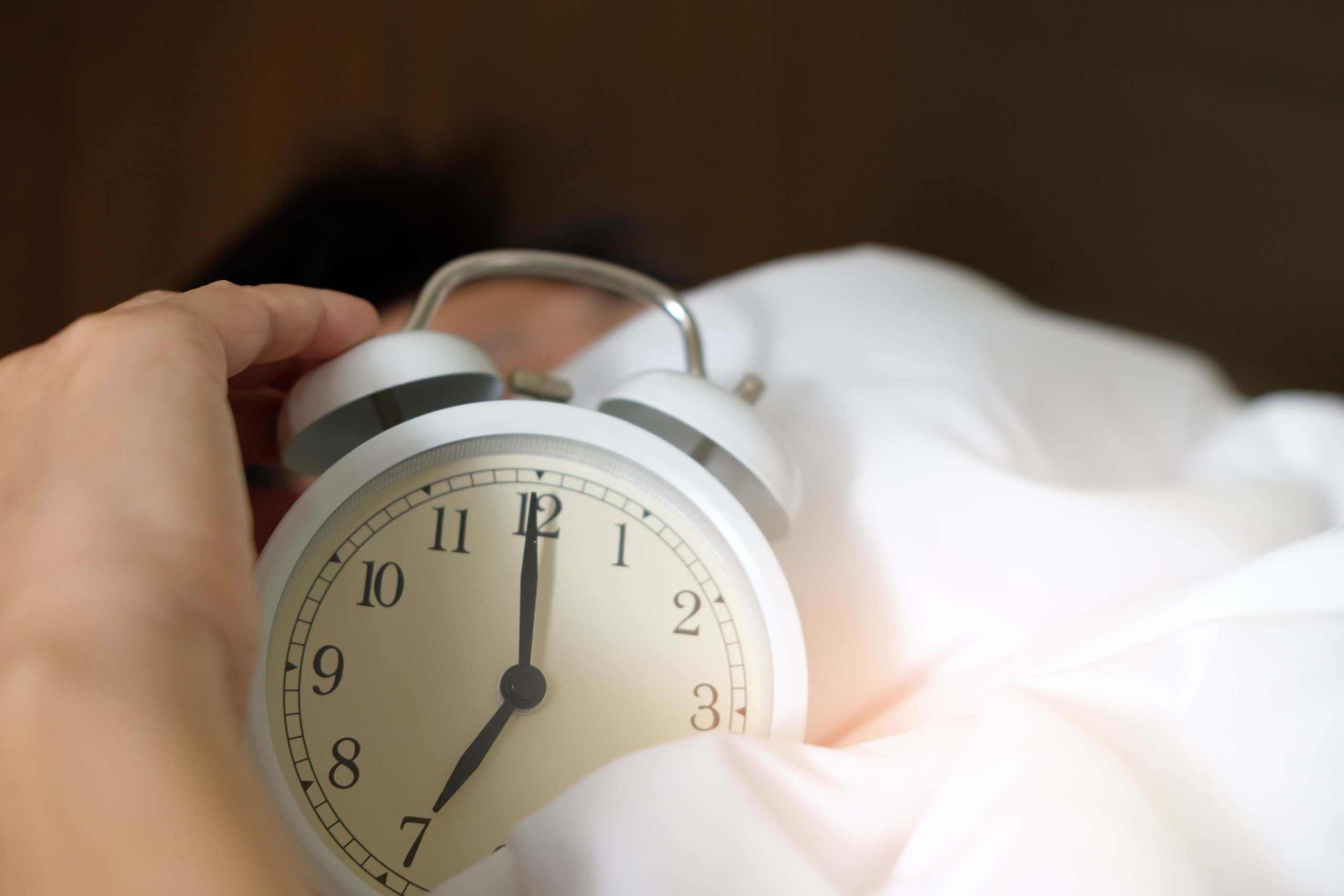 Alarm clock representing disrupted sleep patterns and the impact of burnout on healthy rest through burnout therapy in Denver, CO.