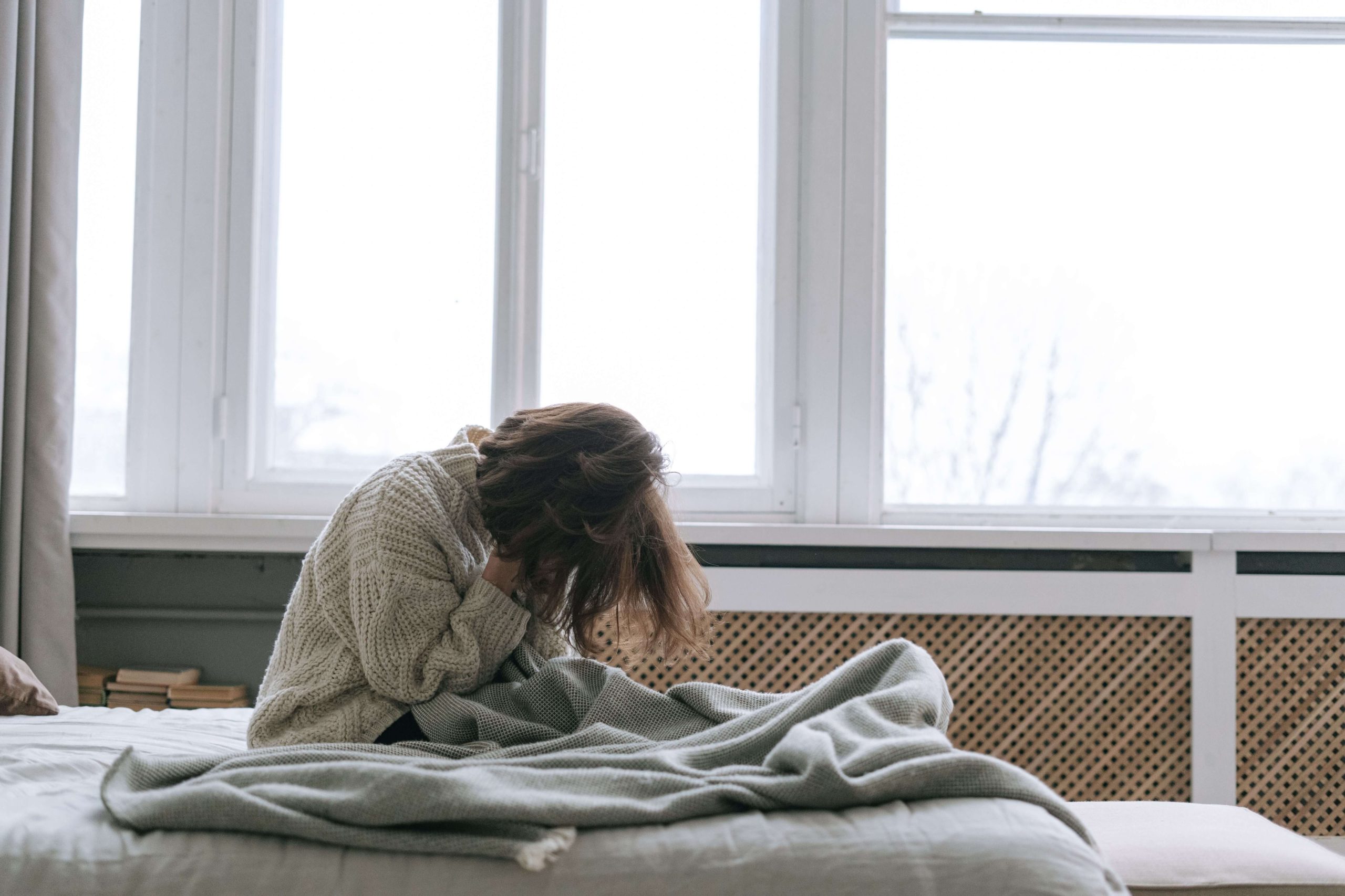 Person awake in bed and unable to sleep, illustrating nighttime restlessness and sleep challenges addressed through personalized sleep therapy in Denver, CO.